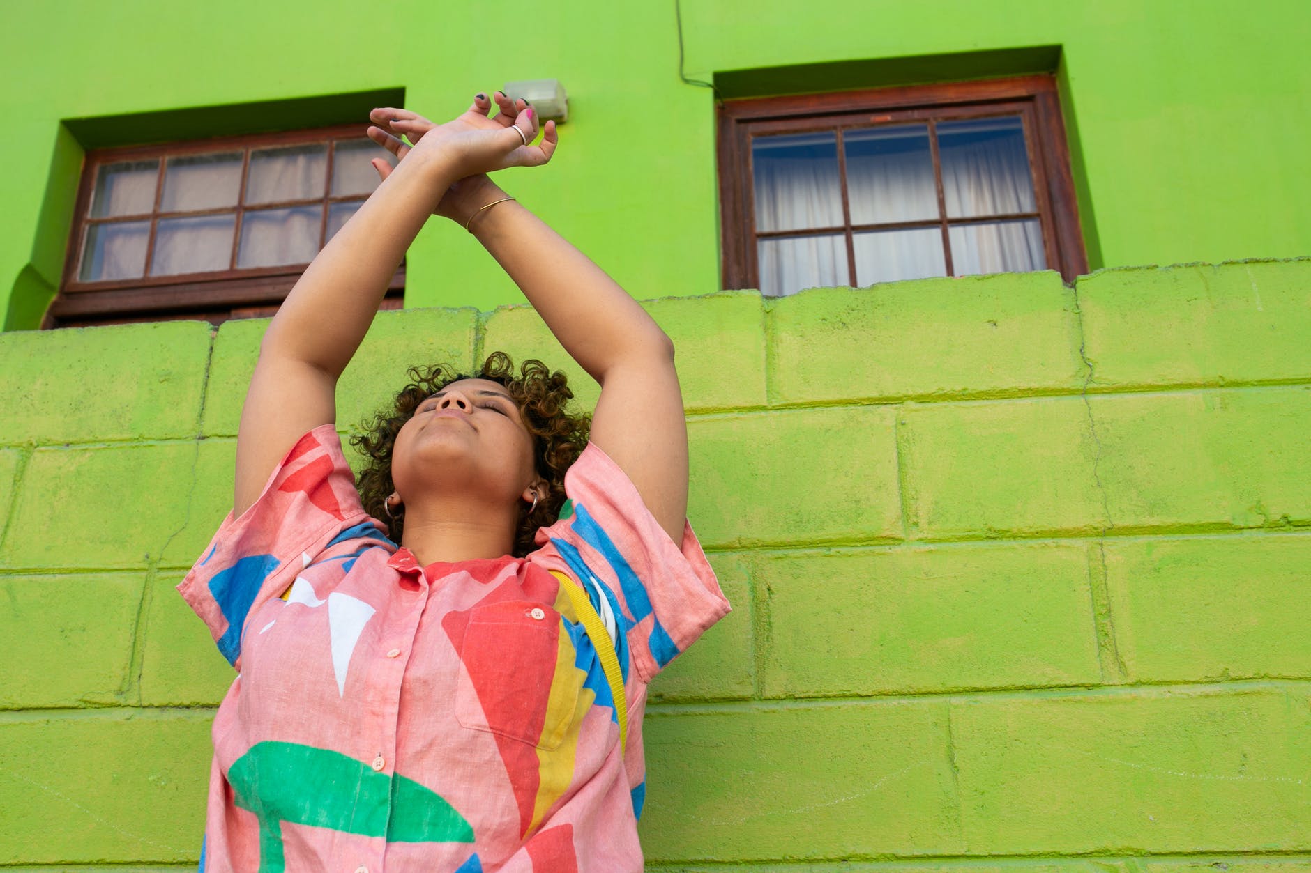 satisfied woman in front of bright wall